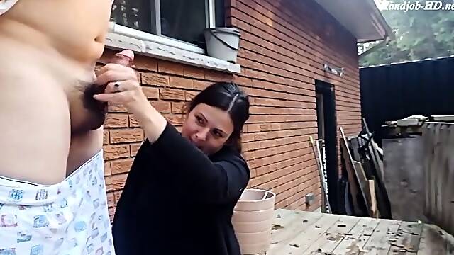 Amateur milf jerking off husbands meat pole outside