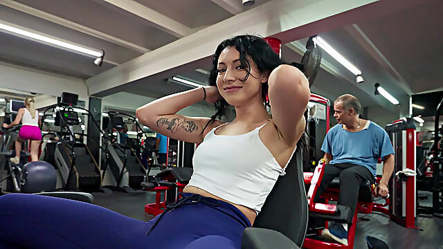Tattooed MILF sucks cock and rides reverse on gym floor