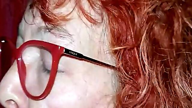 Redhead granny with glasses sucking a youthful bbc