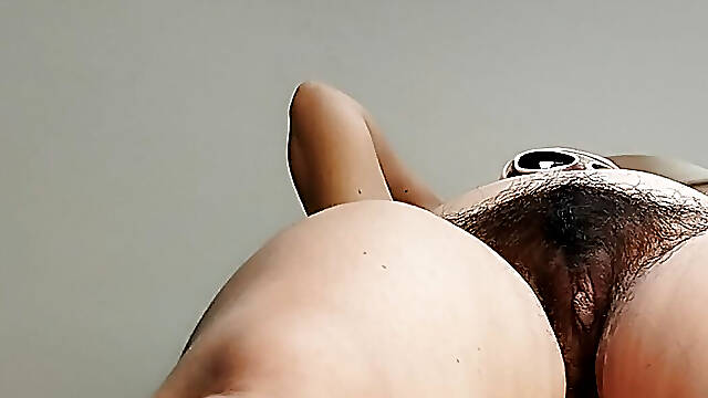 Amateur MILF massages herself with a vibrator.